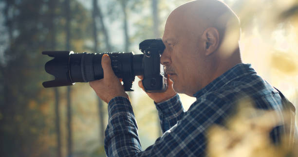 istock Wildlife photographer shooting in a forest 1306451726