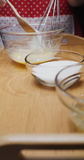 istock Making French crepe batter at home. Adding sugar. Close-up vertical front view 1306453456