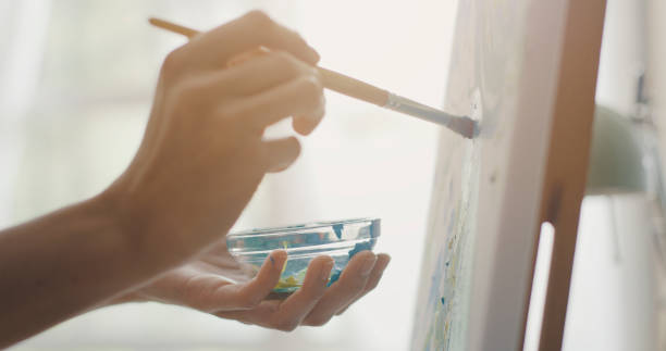 istock Creative artist painting on canvas 1306453628