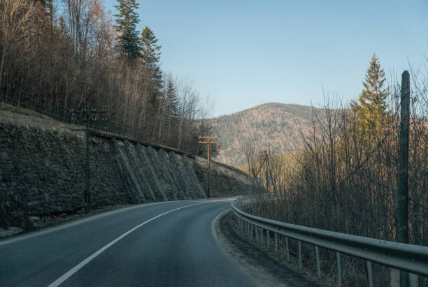 istock Winding road through a mountain pass in early spring 1306454029