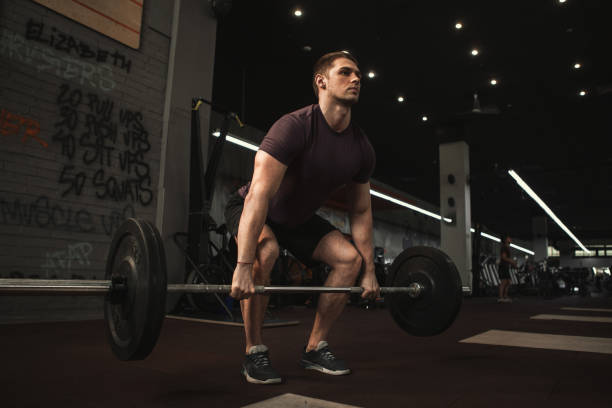 istock Young strong male athlete working out at the gym 1306455381