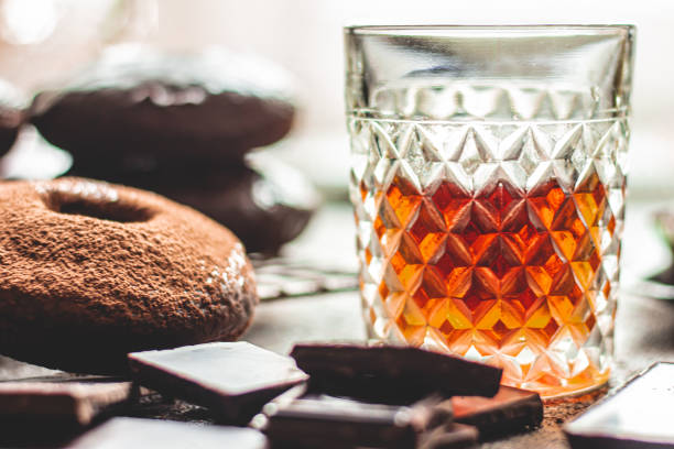 whiskey on a background of chocolate donuts and the chocolate. - close to food and drink yummy food imagens e fotografias de stock