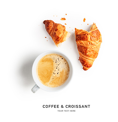 Coffee cup and fresh croissant creative layout on white background. Healthy eating and sweet food concept. French breakfast. Flat lay, top view. Design element
