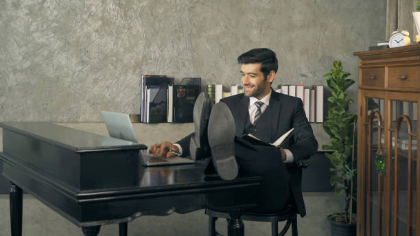 istock Successful smiling middle east business man, CEO person working from home, using a computer notebook laptop device in technology concept. 1306459322