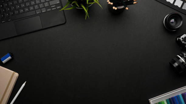 istock Dark creative mock up scene with copy space, camera, stationery, tablet and supplies 1306459539