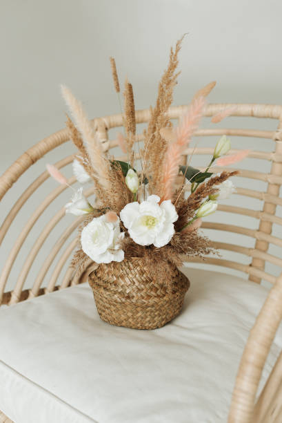 istock artificial decorative flowers in a wicker basket on an armchair 1306459846