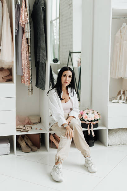 istock young brunette in white shirt sitting in dressing room 1306459880