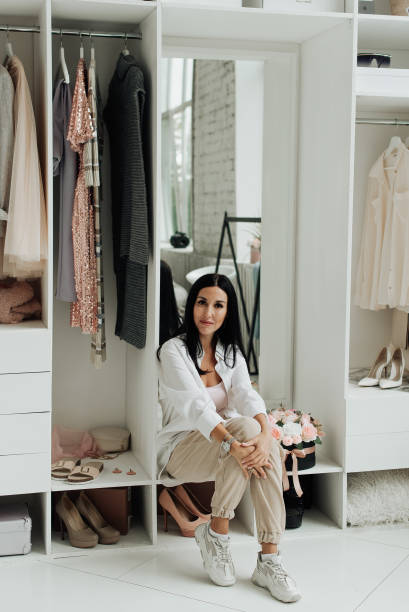 istock young brunette in white shirt sitting in dressing room 1306460065