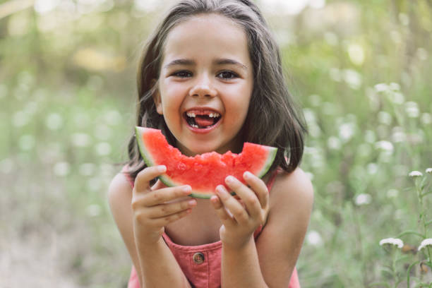 istock The girl is eating a watermelon. 1306464071