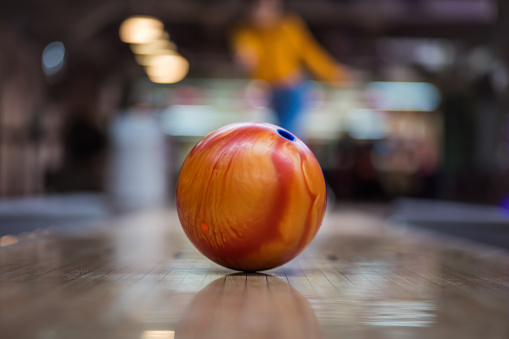 Picture of multiple vibrant bowling balls arranged on a rack