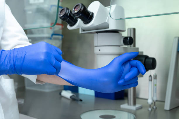 istock The laboratory assistant puts a glove on his hand. 1306464450
