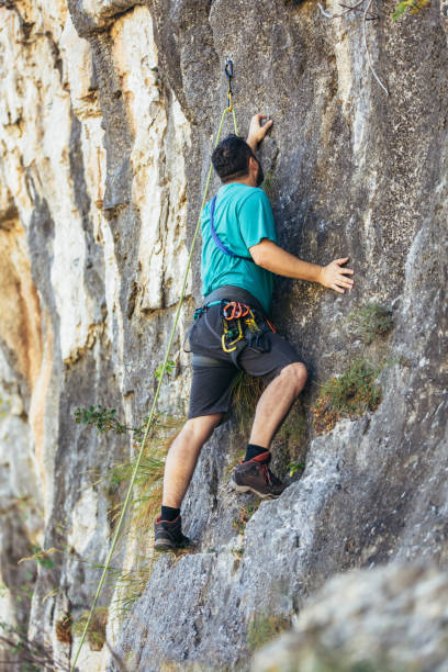 istock Climber climbs on the rock wall. Climbing gear. Climbing equipment. 1306466544
