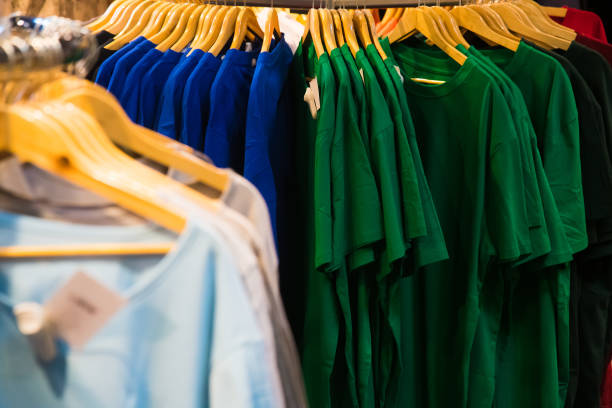 istock T-shirts on hangers in the store 1306472353