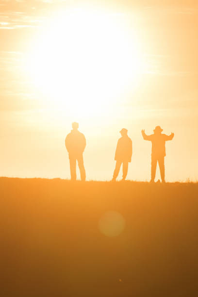 istock Travelers silhouettes against the orange light 1306473052
