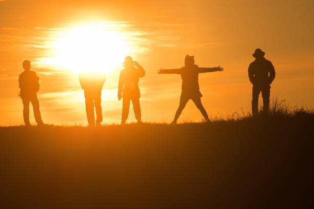 istock Travelers silhouettes against the orange light 1306473081