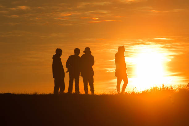 istock Travelers silhouettes against the orange light 1306473096