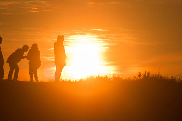 istock Travelers silhouettes against the orange light 1306473098