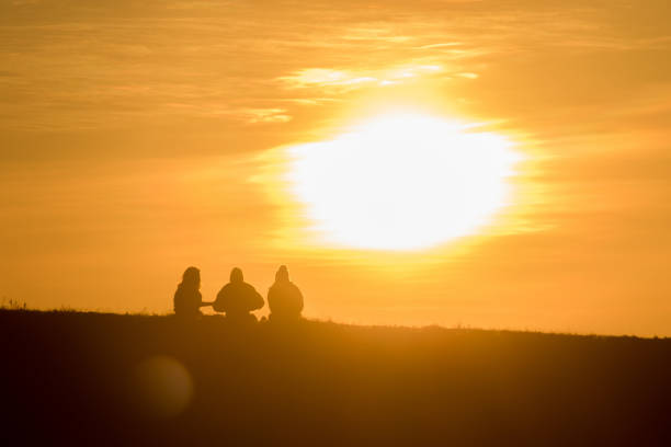 istock Travelers silhouettes against the orange light 1306473143