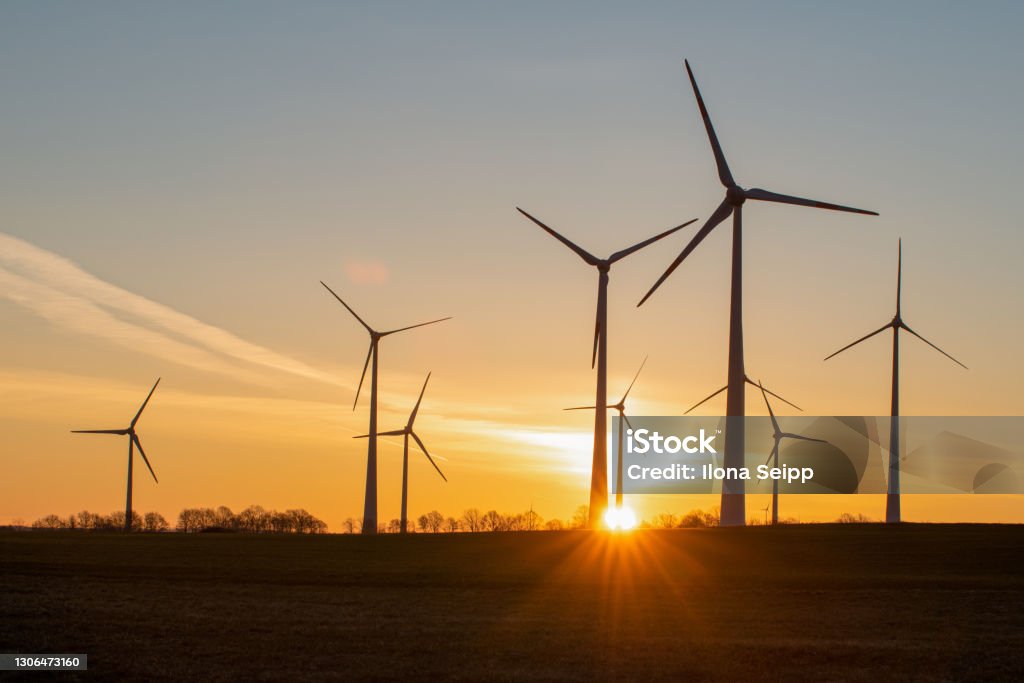 windmilles wind turbines in the rising sun Wind Power Stock Photo