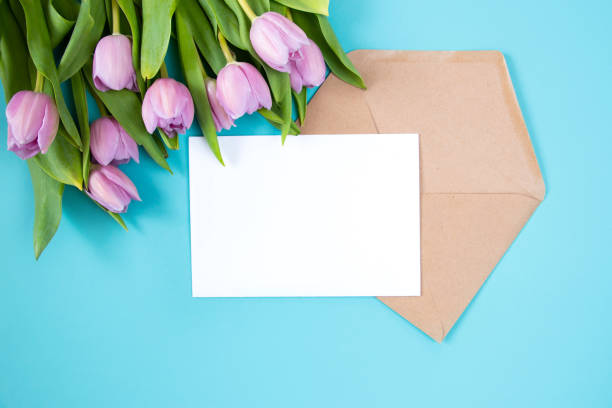 istock Tulips on a blue background. Festive floral concept with clean text space. Flat lay. View from above. 1306474411