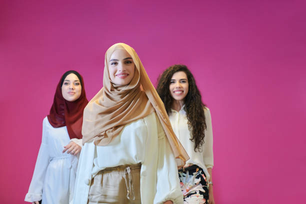 istock Young muslim women posing on pink background 1306474640