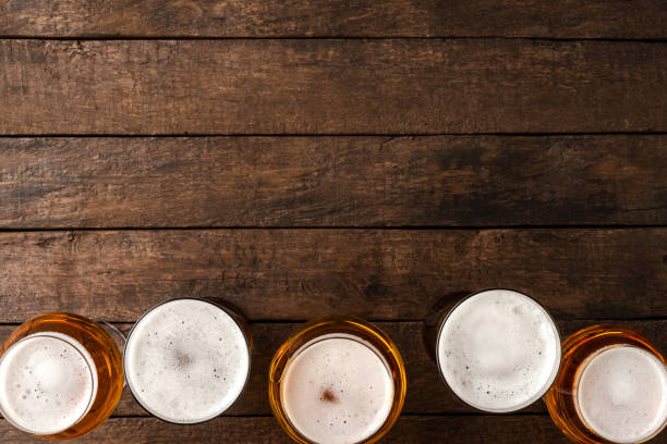 istock Beer glasses on wooden table with copyspace. 1306476849