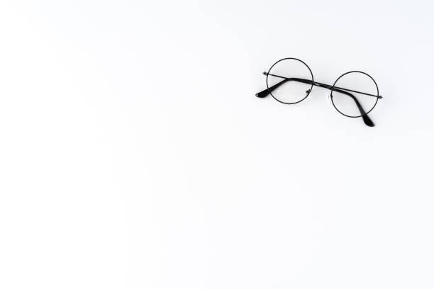 istock Overhead shot of round eyeglasses on white table with copyspace 1306477457