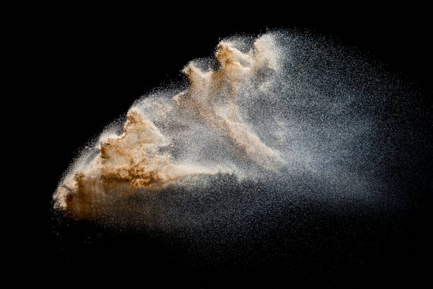 istock Sand explosion isolated on black background. Freeze motion of sandy dust splash. 1306478402