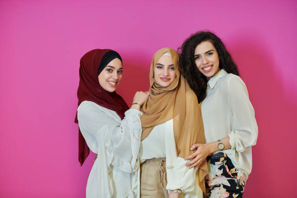istock Young muslim women posing on pink background 1306480840