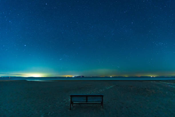 Bench on the starry sky and sandy beach