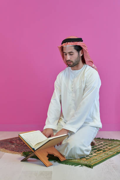 istock Young muslim man reading Quran during Ramadan 1306481741