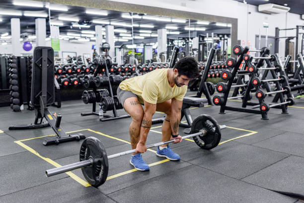 istock Latin Man Preparing For Deadlift In Gym With Barbell 1306483375