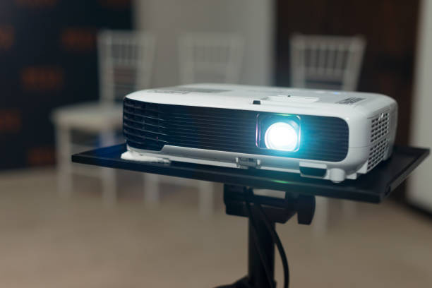 Photo of a working projector in an office or at home. stock photo