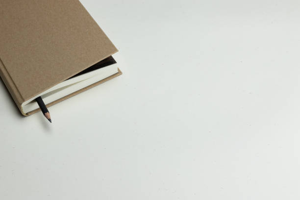 istock Notebook with a hardcover brown on a light background, a place to record 1306488680