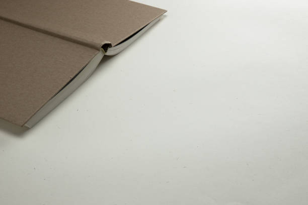 istock Notebook with a hardcover brown on a light background, a place to record 1306488761