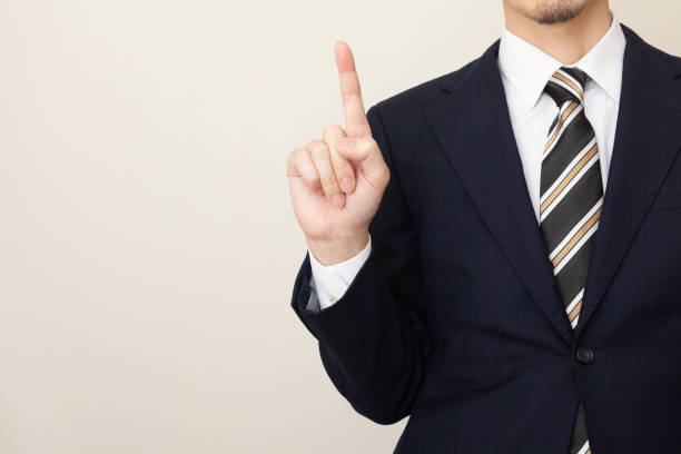 istock A man in a suit explaining the points with a gesture of raising the index finger 1306489322