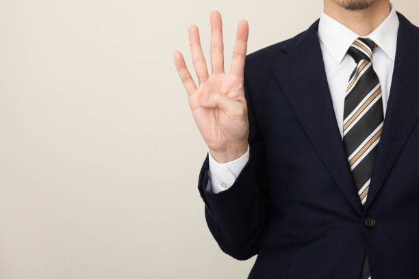 istock A man in a suit with four fingers 1306489408