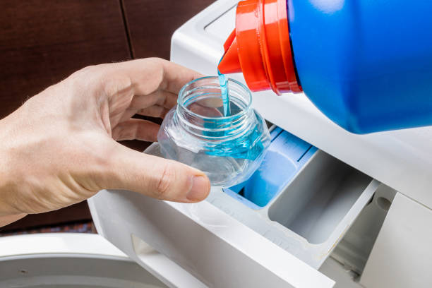 istock laundry using liquid detergent concept. person pouring detergent to washing machine. hygiene housework conceptual 1306491186