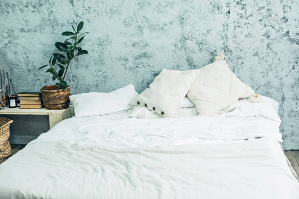 istock Loft style interior. Bed and gray wall. 1306492589
