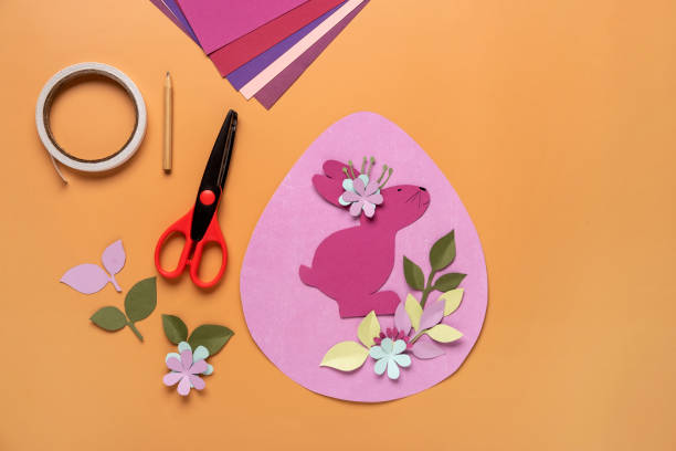 istock Step 11. Step by step instruction: how to make a Easter card out of colored cardboard. Easter card with bunny. 1306492653