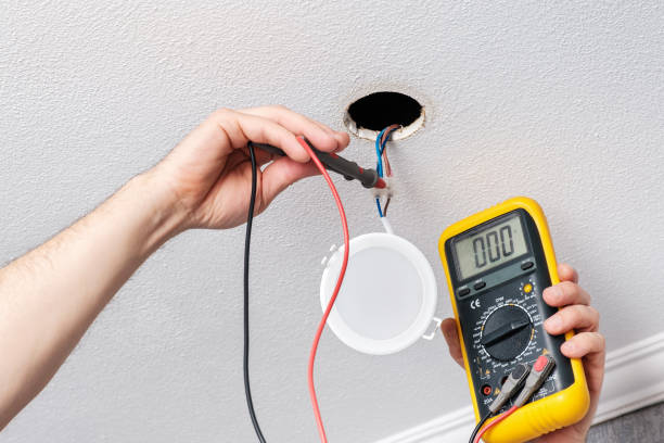 istock Electrician hands check with tester power supply before installing LED light 1306493394