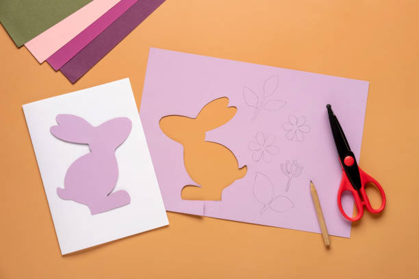 istock Step 4. Step by step instruction: how to make a Easter card out of colored cardboard. Easter card with bunny. 1306493450