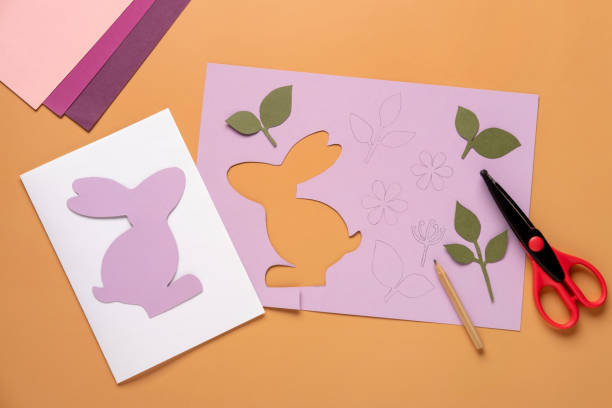 istock Step 5. Step by step instruction: how to make a Easter card out of colored cardboard. Easter card with bunny. 1306493543
