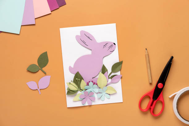 istock Step 8. Step by step instruction: how to make a Easter card out of colored cardboard. Easter card with bunny. 1306493710
