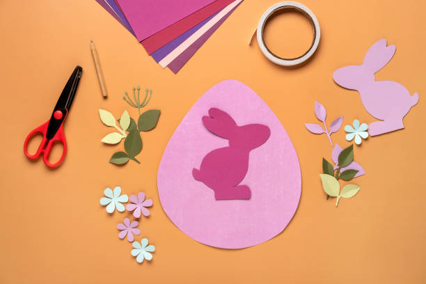 istock Step 9. Step by step instruction: how to make a Easter card out of colored cardboard. Easter card with bunny. 1306493770