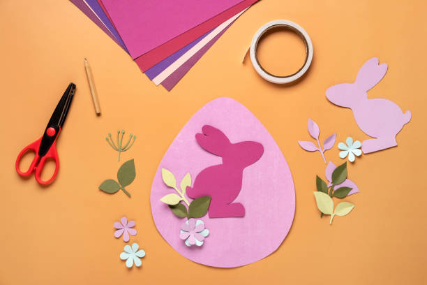 istock Step 10. Step by step instruction: how to make a Easter card out of colored cardboard. Easter card with bunny. 1306493804