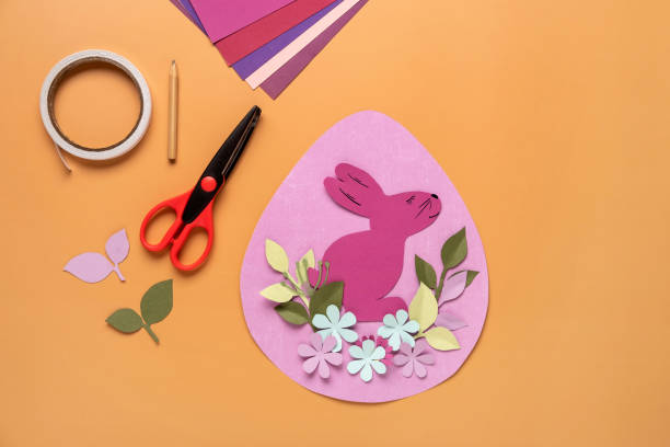 istock Step 11. Step by step instruction: how to make a Easter card out of colored cardboard. Easter card with bunny. 1306493836