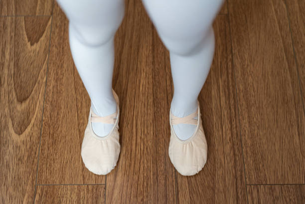 istock Little Dancer Standing on Wood Floor 1306494865