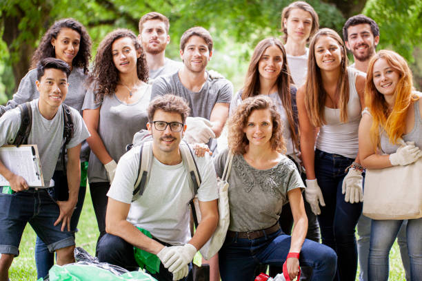 istock Group of mutiethnic environmental activists posing for the camera in a park 1306495207