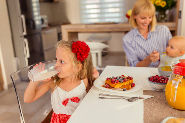 istock Mother having breakfast with her children 1306495314